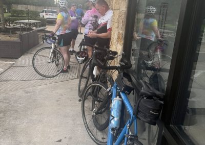 Cycling In Houston - NWCC Recent Activities Gallery 455 Cyclists gathering outside a café, part of Northwest Cycling Club event, promoting community and outdoor activity.