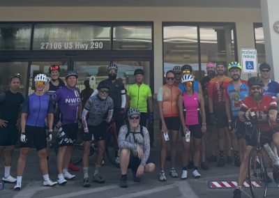 Cycling In Houston - NWCC Recent Activities Gallery 453 Group of cyclists at Northwest Cycling Club before ride, in front of bike shop.