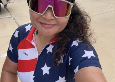 Cycling In Houston - NWCC Recent Activities Gallery 449 Woman cyclist in patriotic USA stars and stripes jersey, wearing helmet and sunglasses at Northwest Cycling Club.
