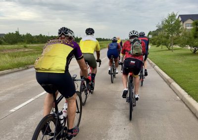 Cycling In Houston - NWCC Recent Activities Gallery 446 Group of cyclists riding on a scenic bike trail with northwest countryside background.