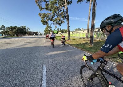 Cycling In Houston - NWCC Recent Activities Gallery 412 Group of cyclists riding on a paved road through a suburban area during a Northwest Cycling Club event.