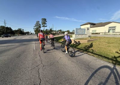 Cycling In Houston - NWCC Recent Activities Gallery 417 Group of cyclists riding on a city street in Northwest Cycling Club event, enjoying outdoor biking.
