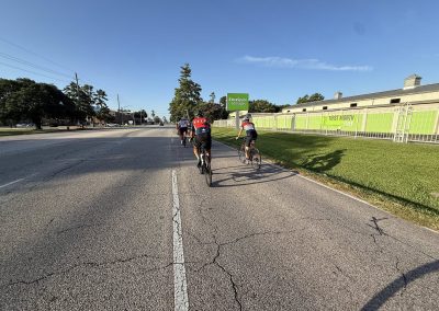 Cycling In Houston - NWCC Recent Activities Gallery 408 Cyclists riding on a city street, promoting outdoor recreation and cycling community.