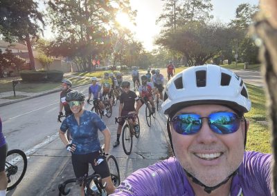 Cycling In Houston - NWCC Recent Activities Gallery 422 Vibrant group cycling with Northwest Cycling Club on scenic suburban streets at sunset.