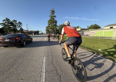 Cycling In Houston - NWCC Recent Activities Gallery 407 Cyclist riding on a street with other members of Northwest Cycling Club, scenic outdoor biking adventure.