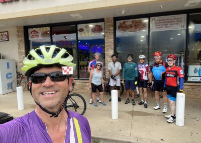 Cycling In Houston - NWCC Recent Activities Gallery 432 Group of cyclists taking a break outside a restaurant, wearing helmets and cycling gear, Northwest Cycling Club.