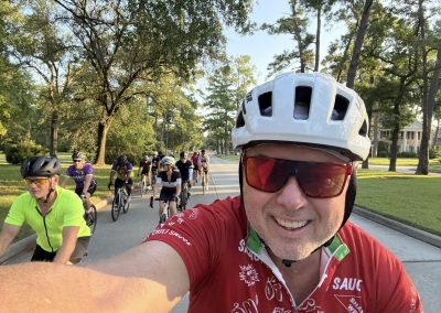 Cycling In Houston - NWCC Recent Activities Gallery 385 Group of cyclists riding together during a Northwest Cycling Club event in a scenic neighborhood.