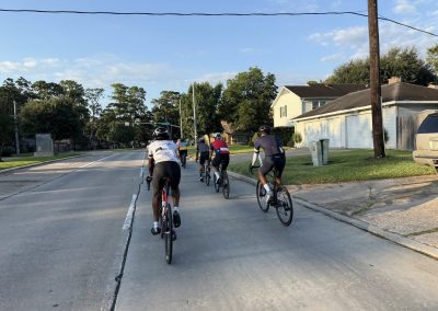 Cycling In Houston - NWCC Recent Activities Gallery 366 Cycling group riding through neighborhood on a sunny day for fitness and recreation.