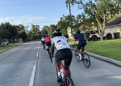 Cycling In Houston - NWCC Recent Activities Gallery 368 Group of cyclists riding on a residential street with trees and houses, part of Northwest Cycling Club.