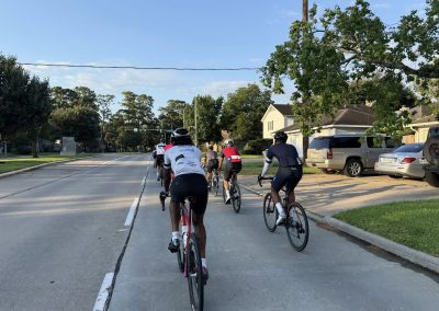 Cycling In Houston - NWCC Recent Activities Gallery 367 Group of cyclists riding through residential neighborhood on Northwest Cycling Club scenic ride.