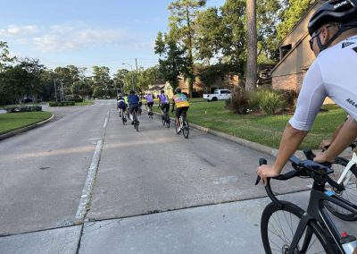 Cycling In Houston - NWCC Recent Activities Gallery 375 Group riding with Northwest Cycling Club on a scenic suburban street during daytime.