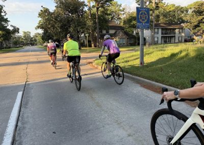Cycling In Houston - NWCC Recent Activities Gallery 384 Cyclists riding together in a suburban neighborhood during a Northwest Cycling Club event.