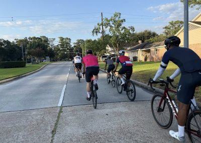 Cycling In Houston - NWCC Recent Activities Gallery 370 Group of cyclists riding on a residential street in the Northwest Cycling Club, outdoor biking event.