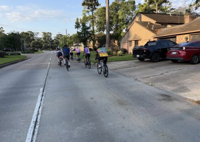Cycling In Houston - NWCC Recent Activities Gallery 376 Bicycle riders on neighborhood street during group cycling event, Northwest Cycling Club active riding session.