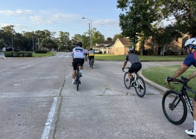Cycling In Houston - NWCC Recent Activities Gallery 372 Cyclists riding through a neighborhood on a group bike ride with Northwest Cycling Club.