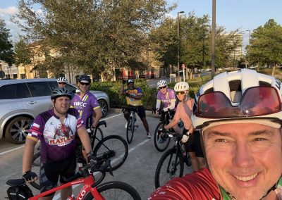 Cycling In Houston - NWCC Recent Activities Gallery 390 Group of cyclists enjoying a ride with Northwest Cycling Club in a city parking lot, showcasing community and outdoor recreation.