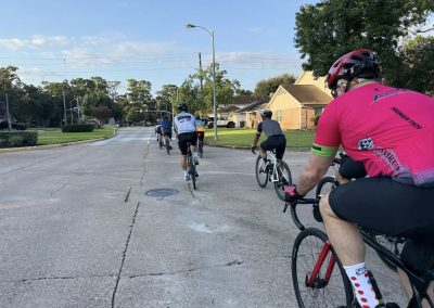 Cycling In Houston - NWCC Recent Activities Gallery 371 Cycling group riding through neighborhood streets with Northwest Cycling Club, promoting community and fitness.