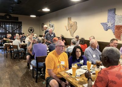 Cycling In Houston - NWCC Recent Activities Gallery 363 Community gathering of Northwest Cycling Club members enjoying a meal at a Texas-themed restaurant.