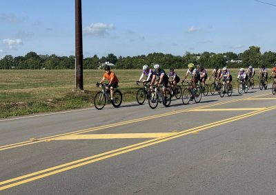 Cycling In Houston - NWCC Recent Activities Gallery 357 Cycling group riding on open road with scenic countryside in the background.