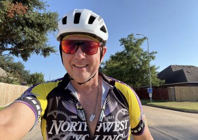 Cycling In Houston - NWCC Recent Activities Gallery 360 Smiling cyclist in riding gear, urban street background.