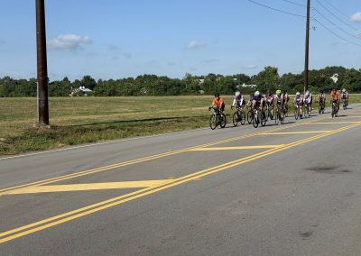 Cycling In Houston - NWCC Recent Activities Gallery 359 Group of cyclists riding on a scenic rural road, promoting Northwest Cycling Club and cycling community.