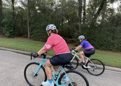 Cycling In Houston - NWCC Recent Activities Gallery 338 Women cycling on bicycles in a park, promoting fitness and outdoor recreation with Northwest Cycling Club.