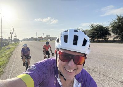 Cycling In Houston - NWCC Recent Activities Gallery 340 Smiling cyclist taking selfies during a Northwest Cycling Club ride on a clear sunny day.
