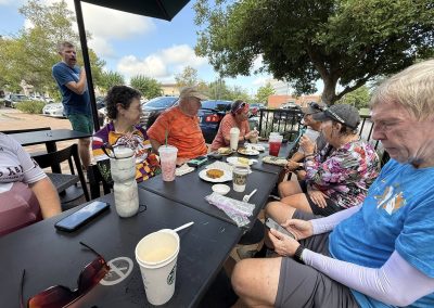Cycling In Houston - NWCC Recent Activities Gallery 354 Group of cyclists enjoying a meal after a ride at Northwest Cycling Club, outdoor cycling social event.