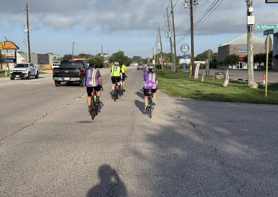Cycling In Houston - NWCC Recent Activities Gallery 347 Cycling group riding on city street - Northwest Cycling Club members enjoying a community bike ride.