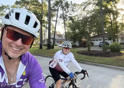 Cycling In Houston - NWCC Recent Activities Gallery 350 Smiling cyclists riding through a suburban neighborhood during a Northwest Cycling Club group ride.
