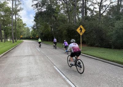 Cycling In Houston - NWCC Recent Activities Gallery 337 Cycling group riding on scenic trail with lush trees in the background.