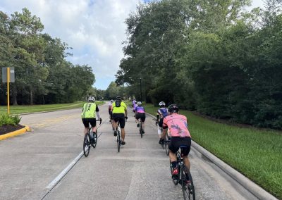 Cycling In Houston - NWCC Recent Activities Gallery 336 Cycling group riding on a scenic tree-lined road for Northwest Cycling Club events and outdoor recreation.