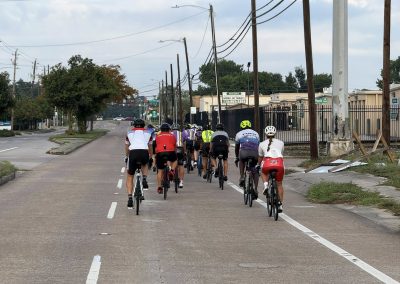 Cycling In Houston - NWCC Recent Activities Gallery 287 Bicycle group ride on city street, promoting camaraderie and outdoor cycling with Northwest Cycling Club.