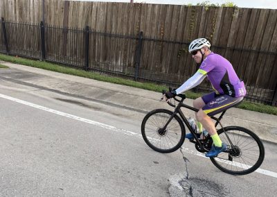 Cycling In Houston - NWCC Recent Activities Gallery 280 Road biking cyclist riding mountain bike on city street in Northwest Cycling Club gear, active outdoor cycling.