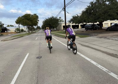 Cycling In Houston - NWCC Recent Activities Gallery 290 Cyclists riding together on a quiet city street, promoting local Northwest Cycling Club activities.