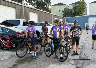 Cycling In Houston - NWCC Recent Activities Gallery 318 Cycling group members gather with bikes outside NWCC Houston cycling club event.