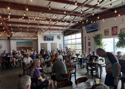 Cycling In Houston - NWCC Recent Activities Gallery 242 Group of cyclists gathering indoors at Portland brewery | northwest cycling club social event in Portland Oregon.
