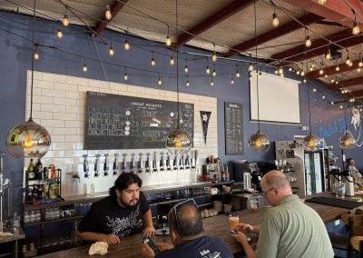 Cycling In Houston - NWCC Recent Activities Gallery 243 Brightly lit brewery featuring cyclists enjoying drinks at Northwest Cycling Club event.