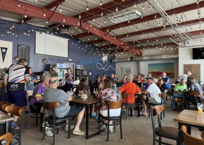 Cycling In Houston - NWCC Recent Activities Gallery 249 Vibrant indoor scene of Northwest Cycling Club members socializing at a lively café gathering.