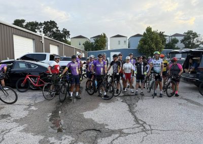 Cycling In Houston - NWCC Recent Activities Gallery 317 Group of cyclists wearing NWCC cycling jerseys at a gathering before ride.