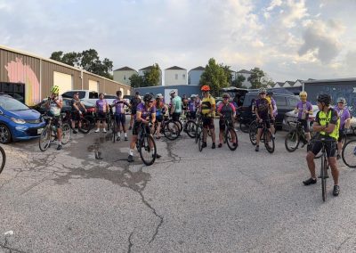 Cycling In Houston - NWCC Recent Activities Gallery 304 Group of cyclists at Northwest Cycling Club gathering for a ride in the parking lot.