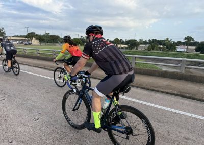 Cycling In Houston - NWCC Recent Activities Gallery 284 Cycling group riding on open road during daytime for Northwest Cycling Club event.