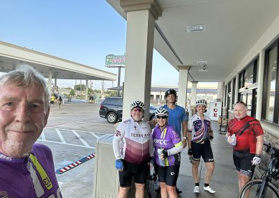 Cycling In Houston - NWCC Recent Activities Gallery 240 Group of cyclists at Northwest Cycling Club event outside a convenience store, ready for ride.