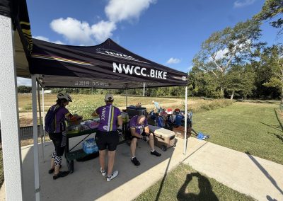 Cycling In Houston - NWCC Recent Activities Gallery 215 Friendly Northwest Cycling Club riders preparing at an outdoor refreshment station for a biking event.