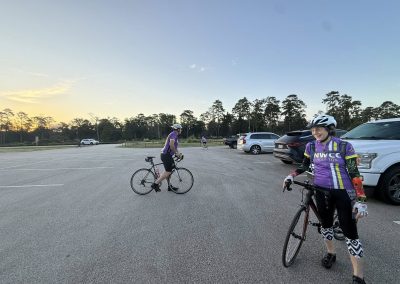 Cycling In Houston - NWCC Recent Activities Gallery 238 Cycling women team NWCC Houston preparing for ride at parking lot during sunset.