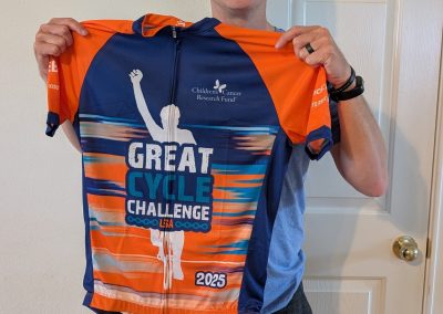 Cycling In Houston - NWCC Recent Activities Gallery 191 Bright man holding Northwest Cycling Club jersey promoting the Great Cycle Challenge 2025.