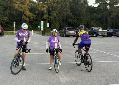 Cycling In Houston - NWCC Recent Activities Gallery 233 Cycling enthusiasts from Northwest Cycling Club discussing routes in a parking lot.