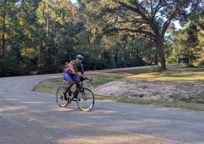 Cycling In Houston - NWCC Recent Activities Gallery 197 Cyclist riding on scenic forest road during daytime for Northwest Cycling Club event.