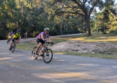 Cycling In Houston - NWCC Recent Activities Gallery 201 Cycling group riding through scenic park in Northwest Cycling Club event.