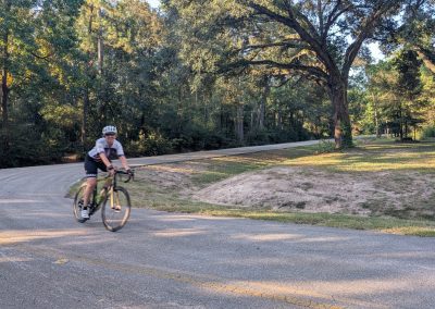 Cycling In Houston - NWCC Recent Activities Gallery 209 Bicycle rider on scenic forested road in Northwest Cycling Club outdoor biking event.